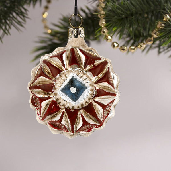 Decorative glass ornament with a colorful kaleidoscope pattern, perfect for enhancing holiday decor.