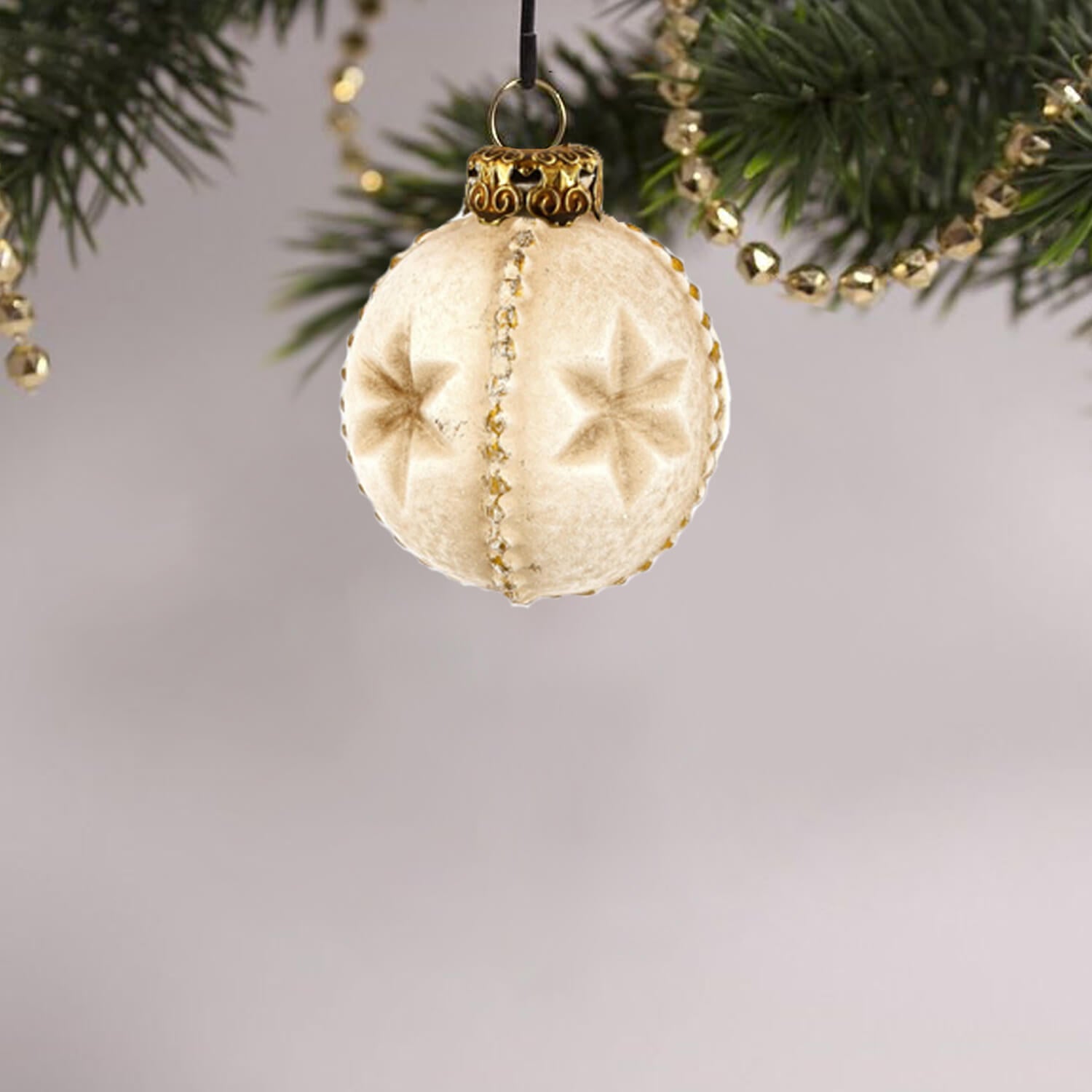 Decorative paper mache star ornament displayed on a Christmas tree.