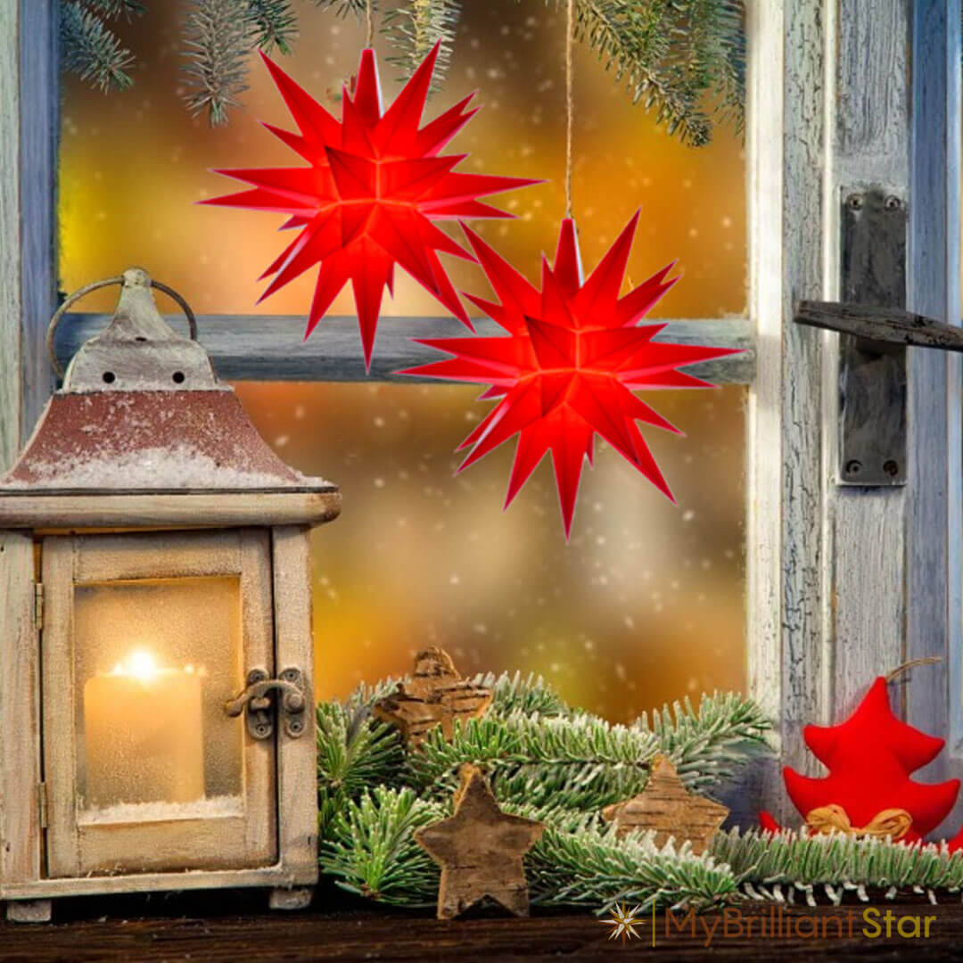Window decorated with 2 Original Herrnhut plastic stars, red, ~ 13 cm / 5 inch ø