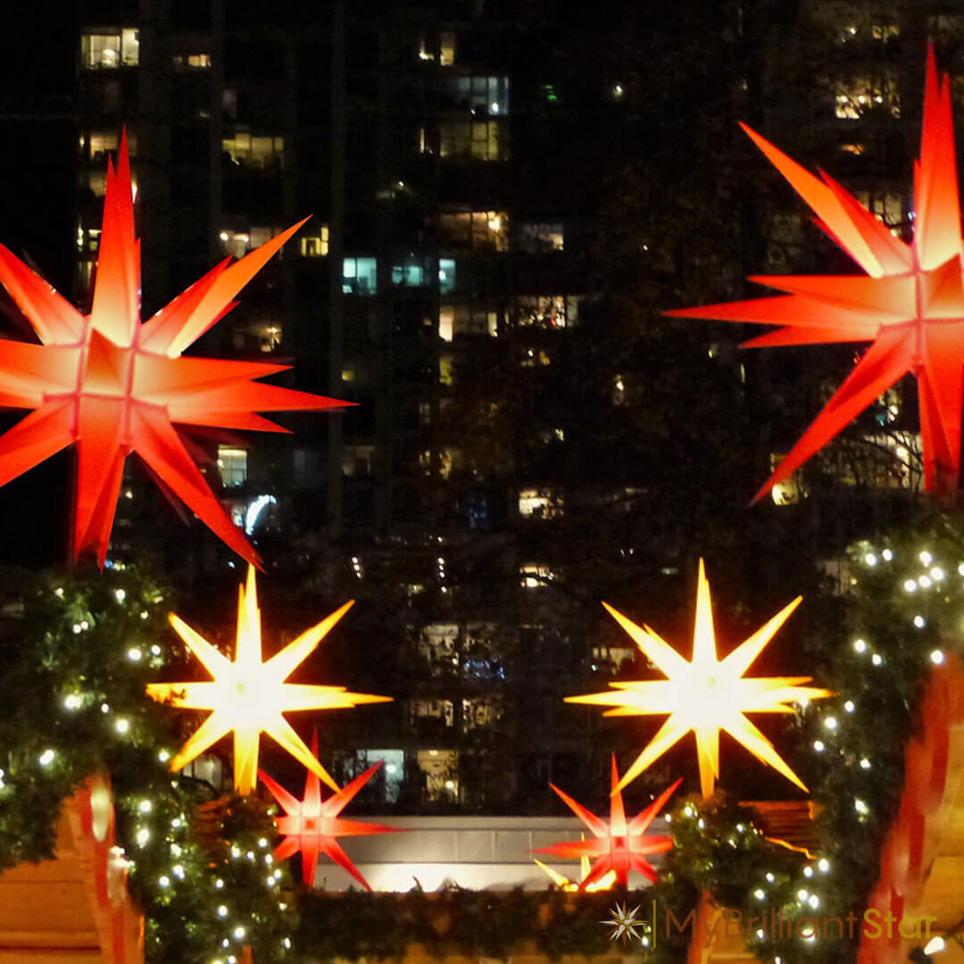 balcony decorated with bright Original Herrnhut plastic star, red, ~ 70 cm / 27 inch ø
