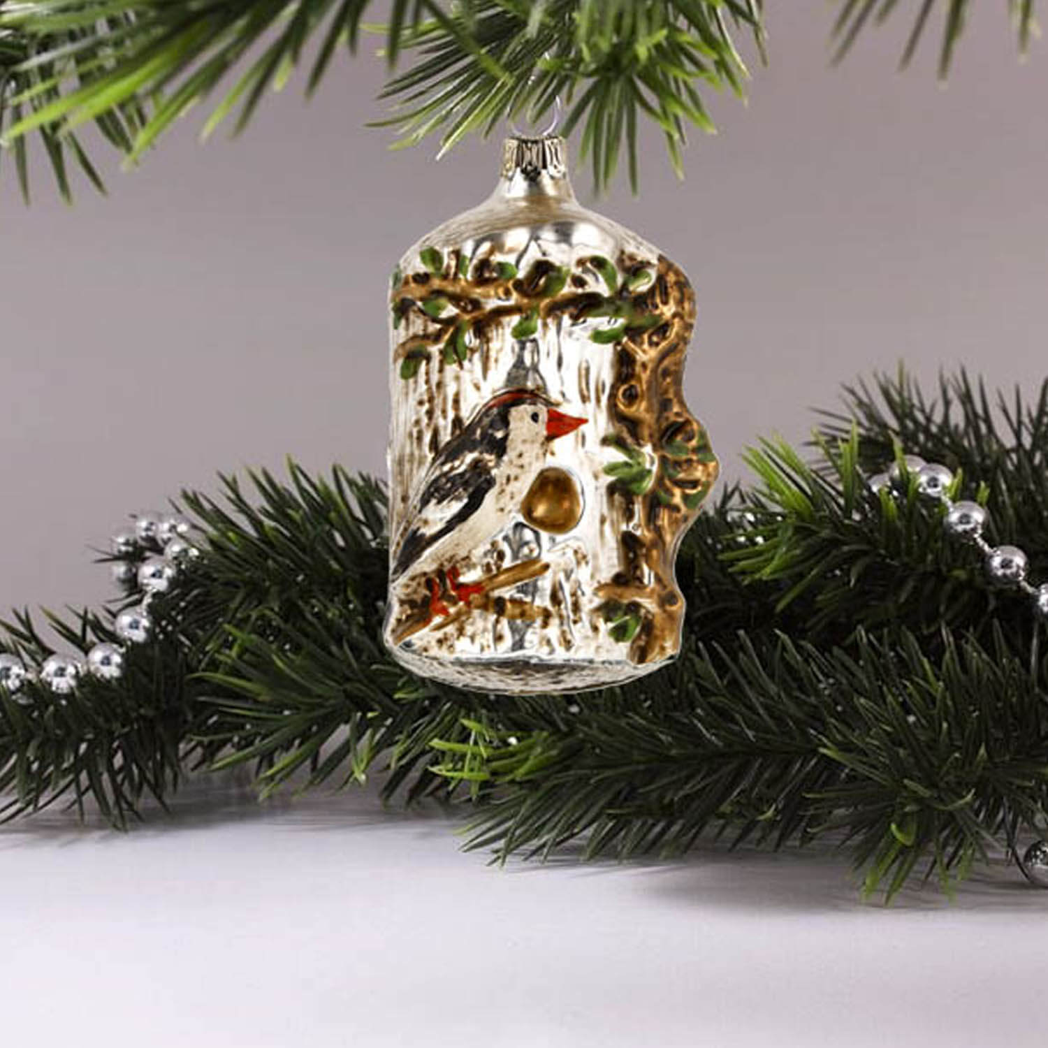 MAROLIN® - Glass ornament "Tree trunk with bird" hanging up