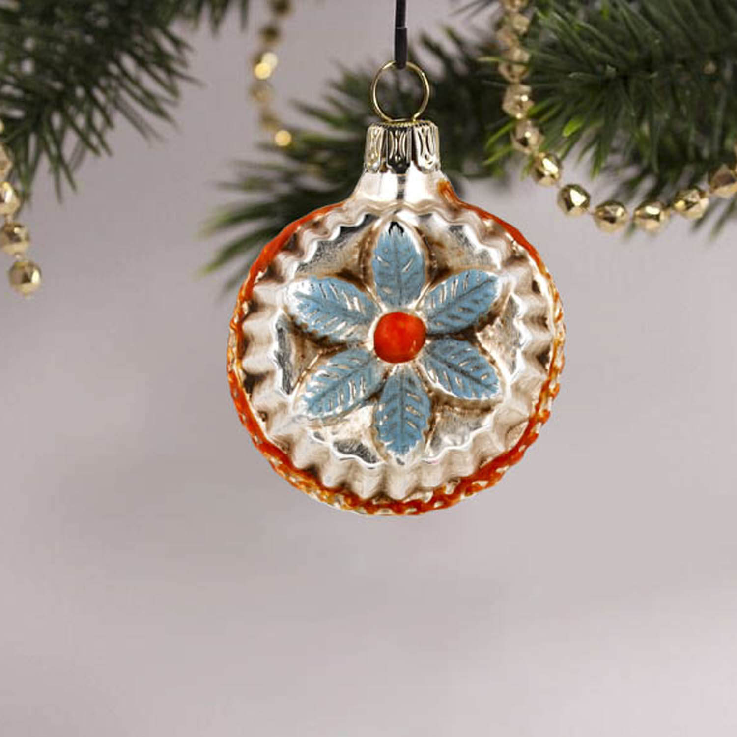 MAROLIN® - Miniature glass ornament "Bloom with jags blue" hanging on decorated Christmas tree
