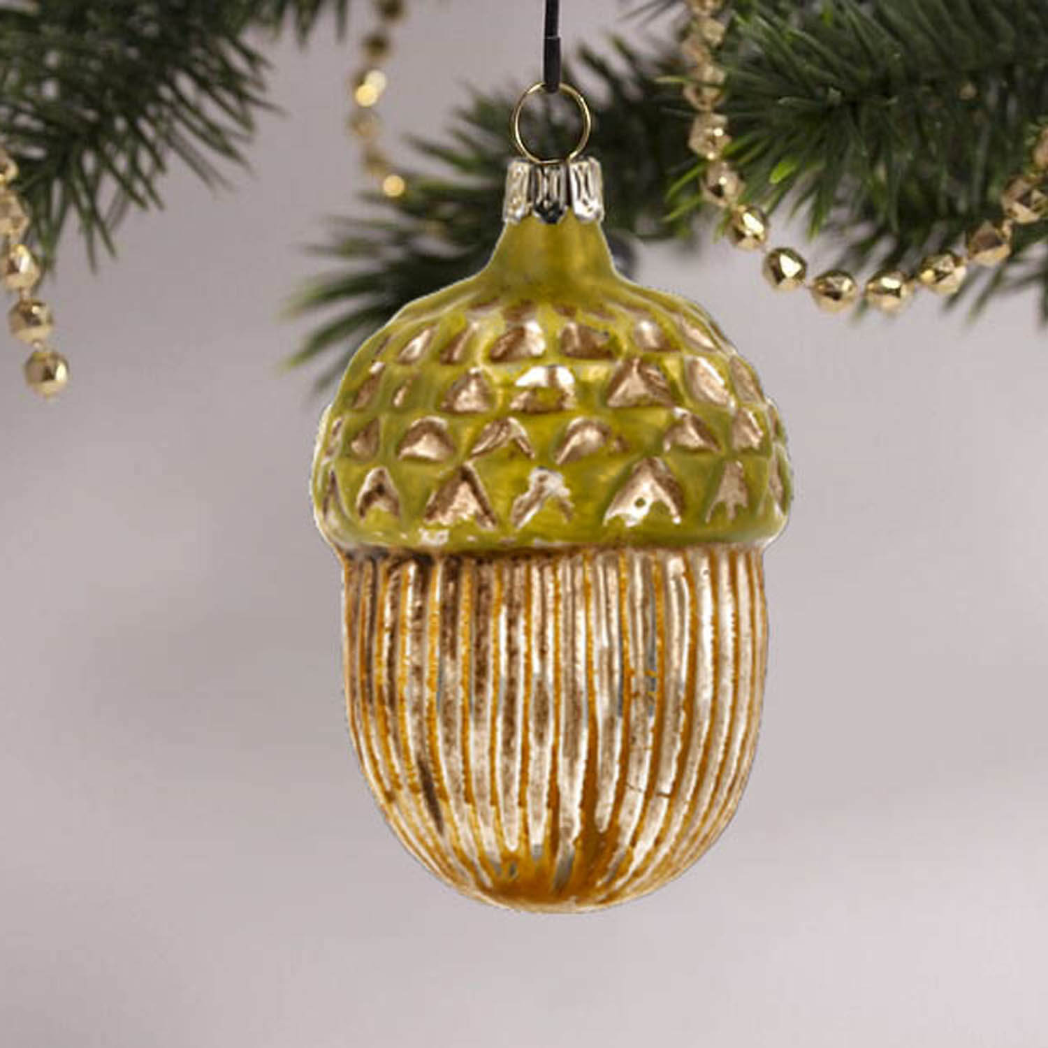 MAROLIN® - Glass ornament "Acorn" on decorated Christmas tree