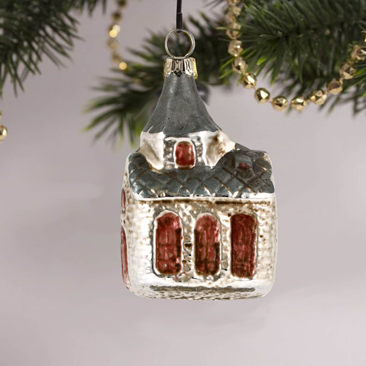 MAROLIN® - Glass ornament "Church with blue roof" hanging on a Christmas tree