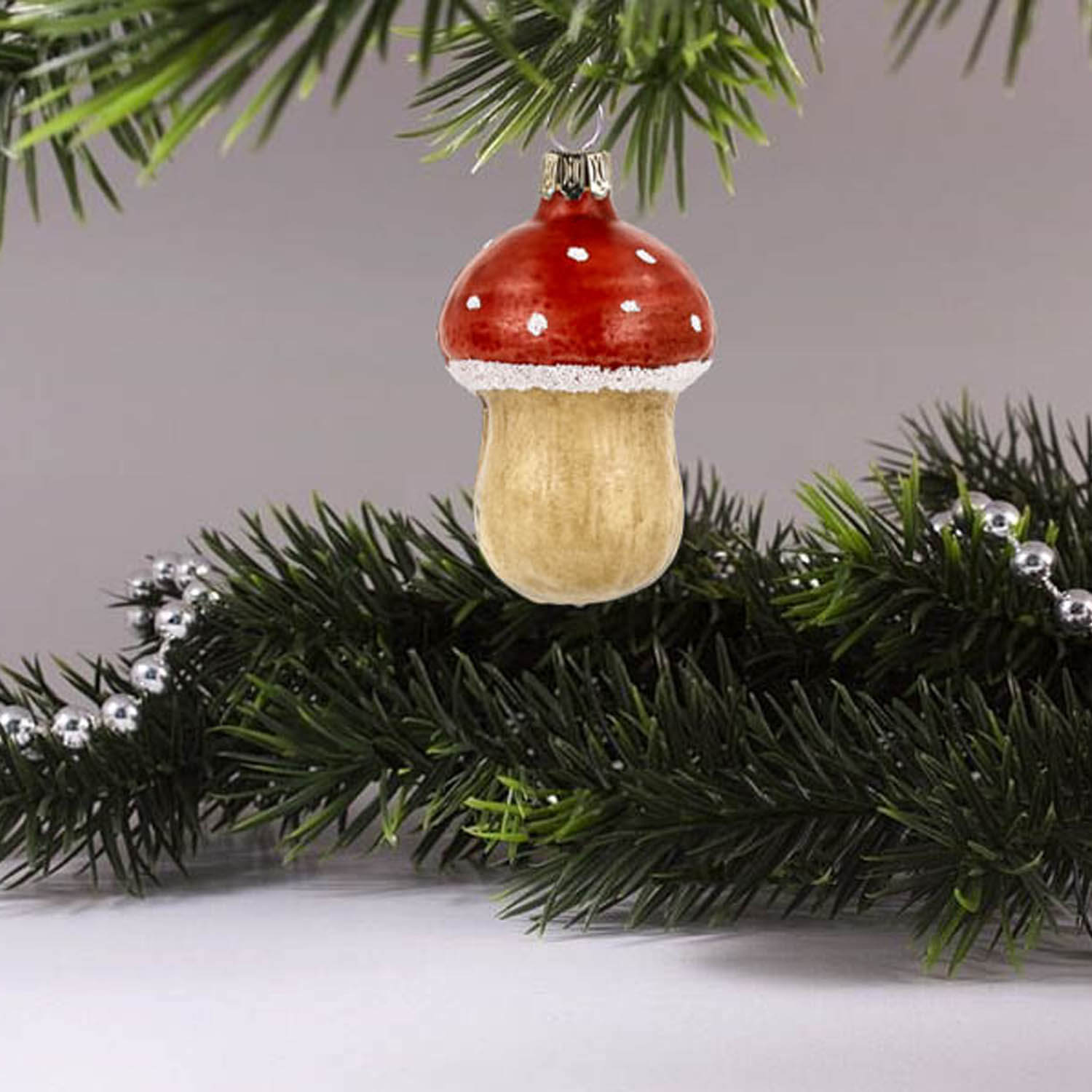 MAROLIN® - Glass ornament "Small fly agaric" hanging on decorated Christmas tree