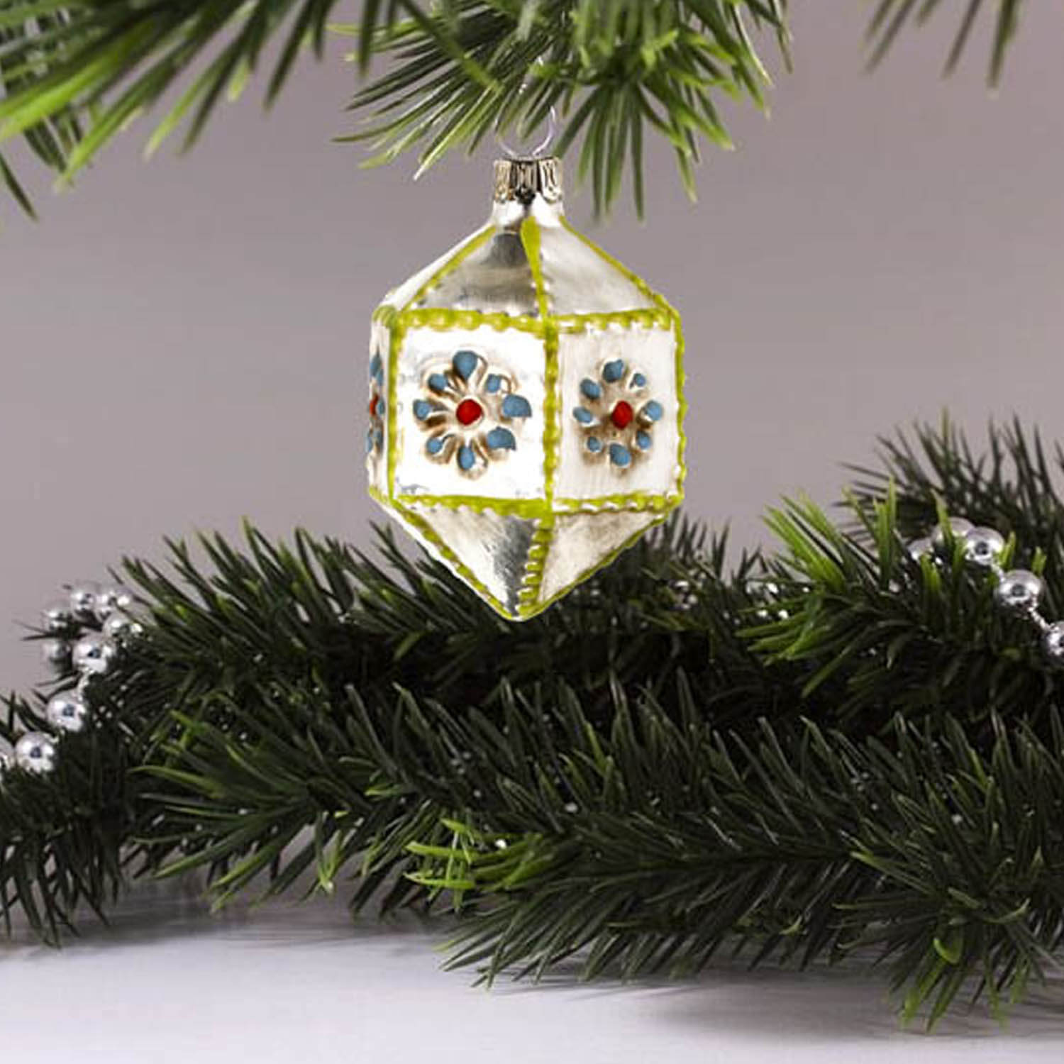 MAROLIN® - Miniature glass ornament "Hexagon with knobs blue" hanging on a Christmas tree