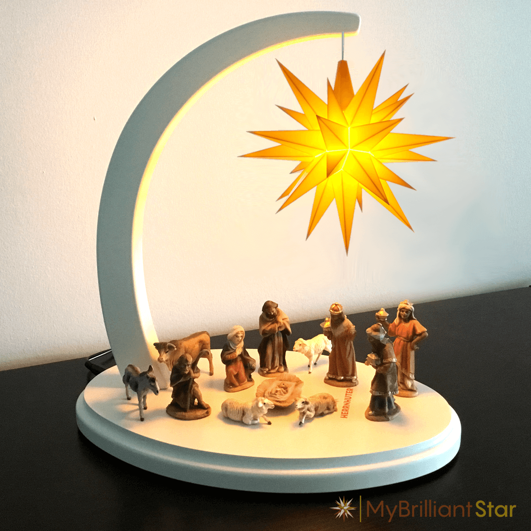 Original MAROLIN® - nativity set, 12 pcs. - 7 cm / 2.75 inch. Figures standing on white star bow under yellow shining Herrnhut plastic star.