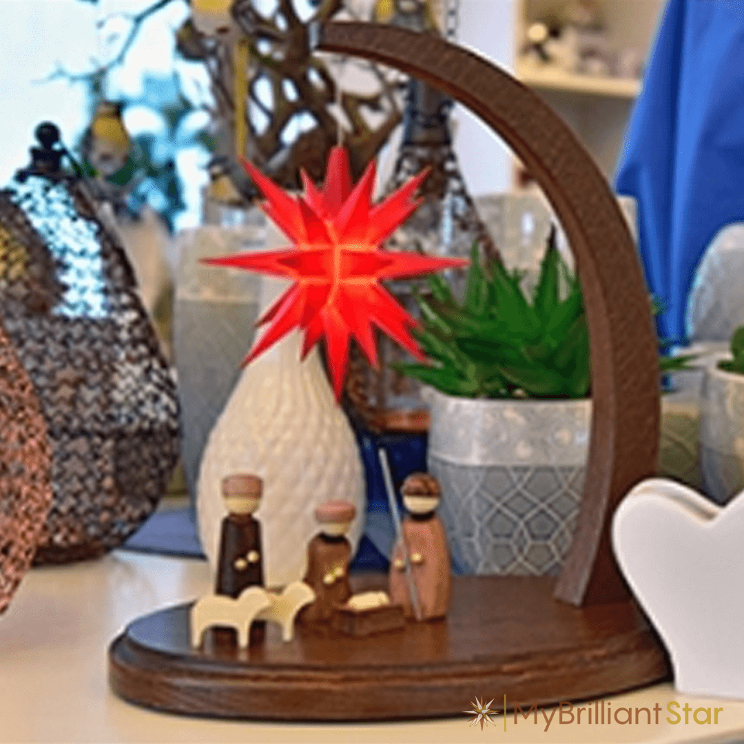 Walnut stained wooden Starbow with bright red star and nativity scene