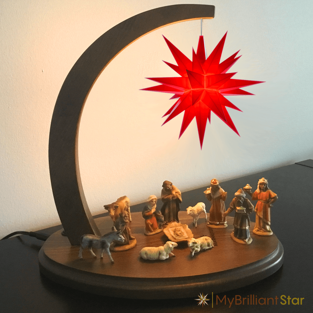 Walnut stained wooden Star bow with red plastic star and nativity scene