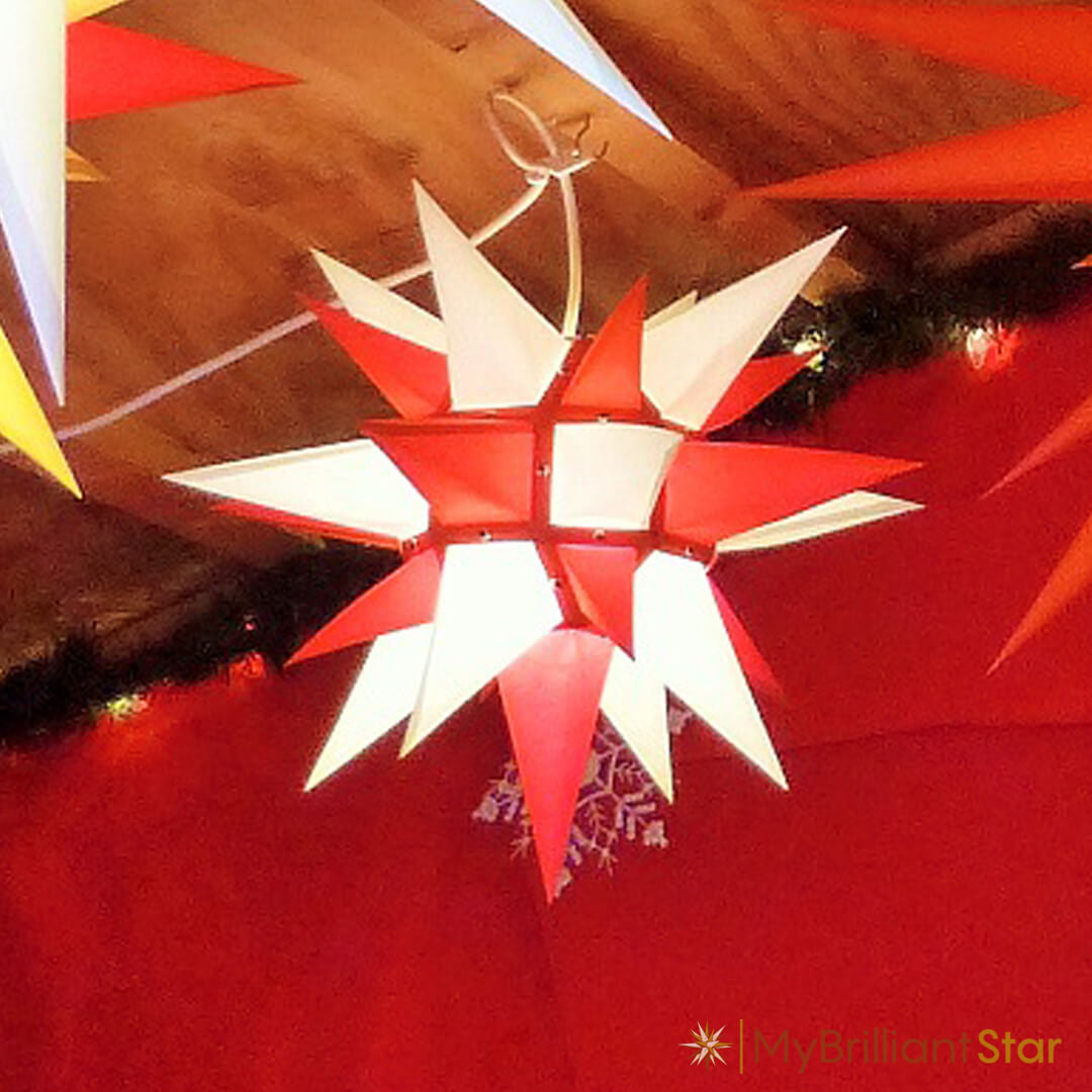 Original Herrnhut paper star, white / red, ~ 40 cm / 16 inch ø in front of red background