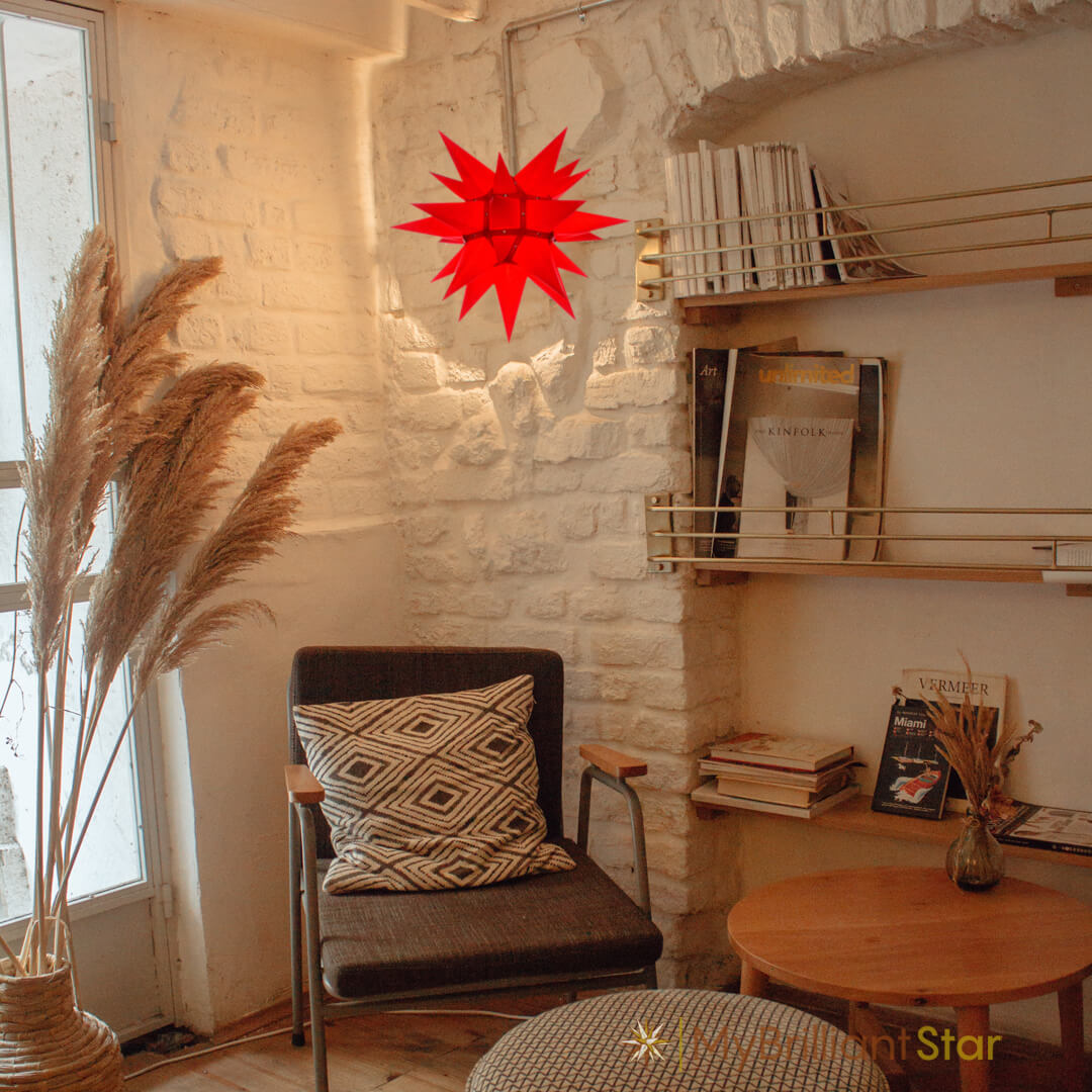 Original Herrnhut paper star, red, ~ 40 cm / 16 inch ø hanging in a living room