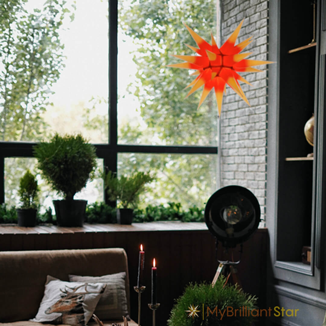 Original Herrnhut paper star, yellow / red center, ~ 60 cm / 24 inch ø hanging in a window
