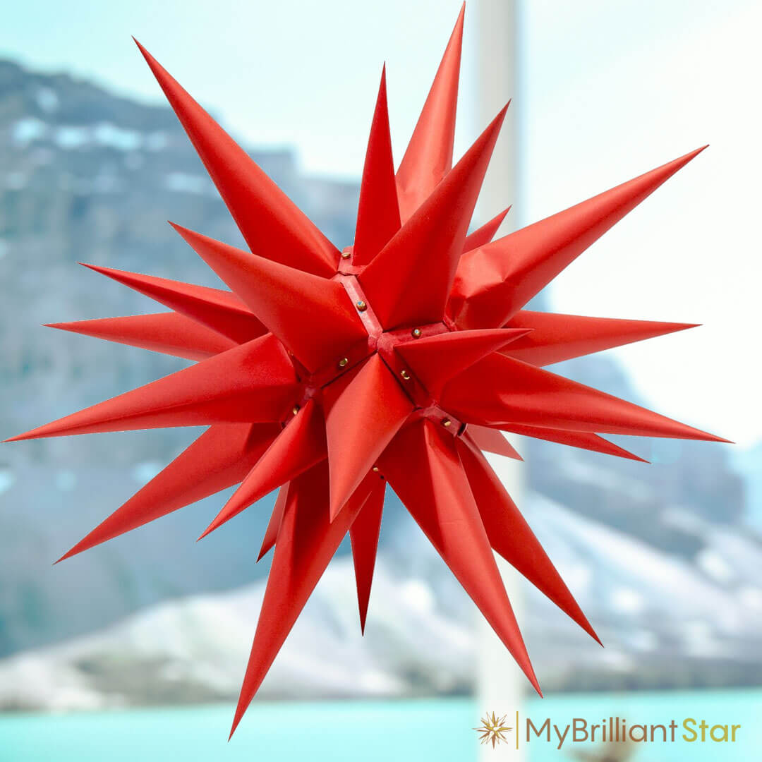 Original Herrnhut paper star, red, ~ 60 cm / 24 inch ø hanging in a window