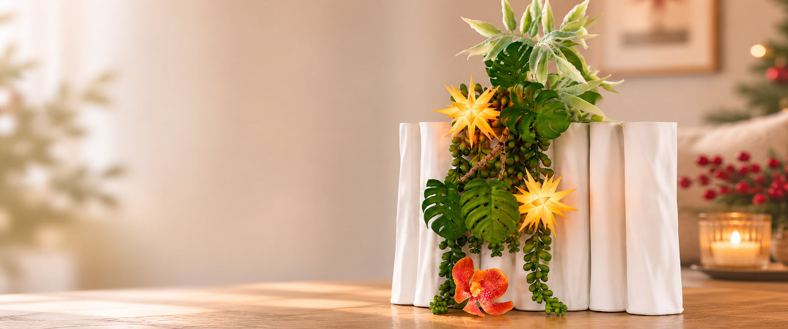 A decorative arrangement in a vase with two apricot colored Herrnhut Ministars in a cozy setting. 