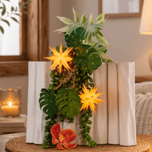 A decorative arrangement in a vase with two apricot colored Herrnhut Ministars in a living room on a table. 
