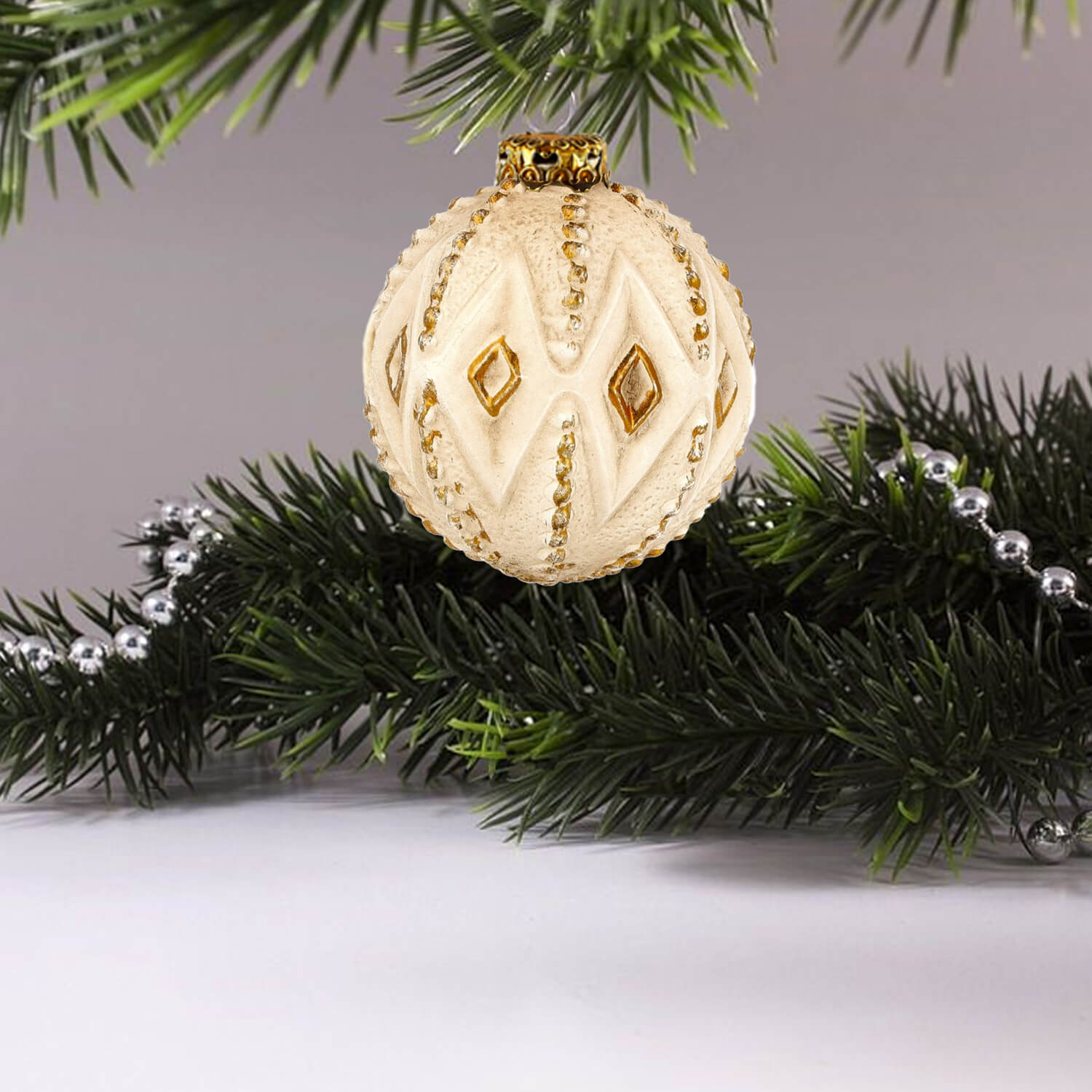 A Paper mache ornament 'Rhombus' with delicate golden rhombuses displayed on a white background.