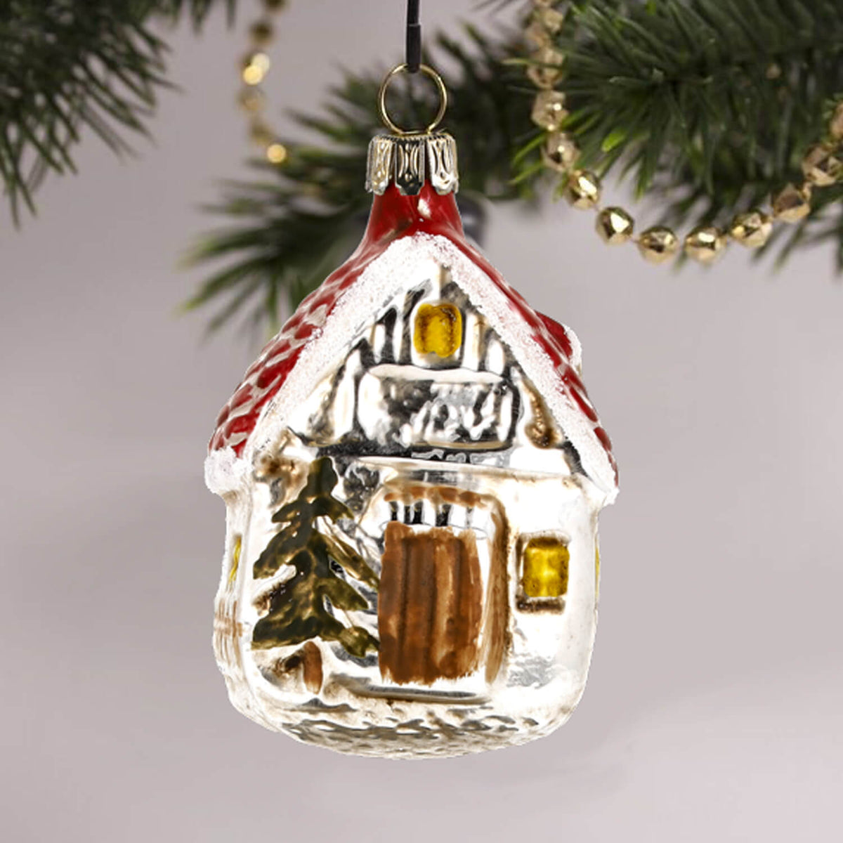 MAROLIN® - Glass ornament "Forest house" hanging on Christmas tree