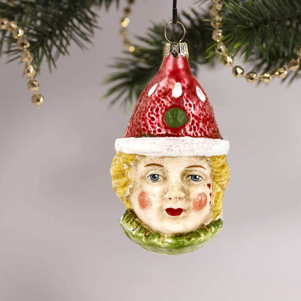MAROLIN® - Glass ornament &quot;Clown with red hat&quot; hanging on a decorated Christmas tree