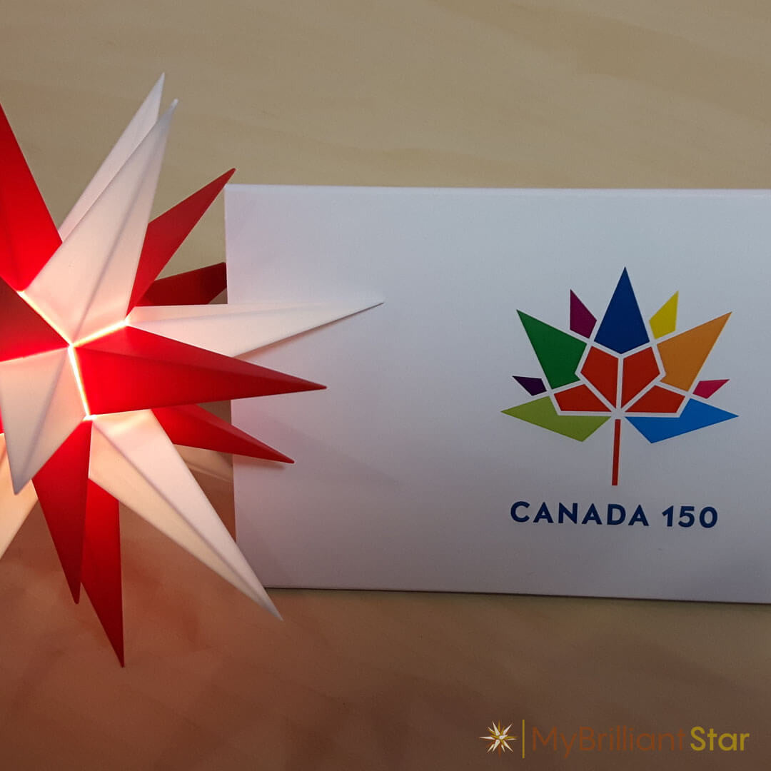 a post card displayed with Original Herrnhut plastic star, white / red, ~ 13 cm / 5 inch ø