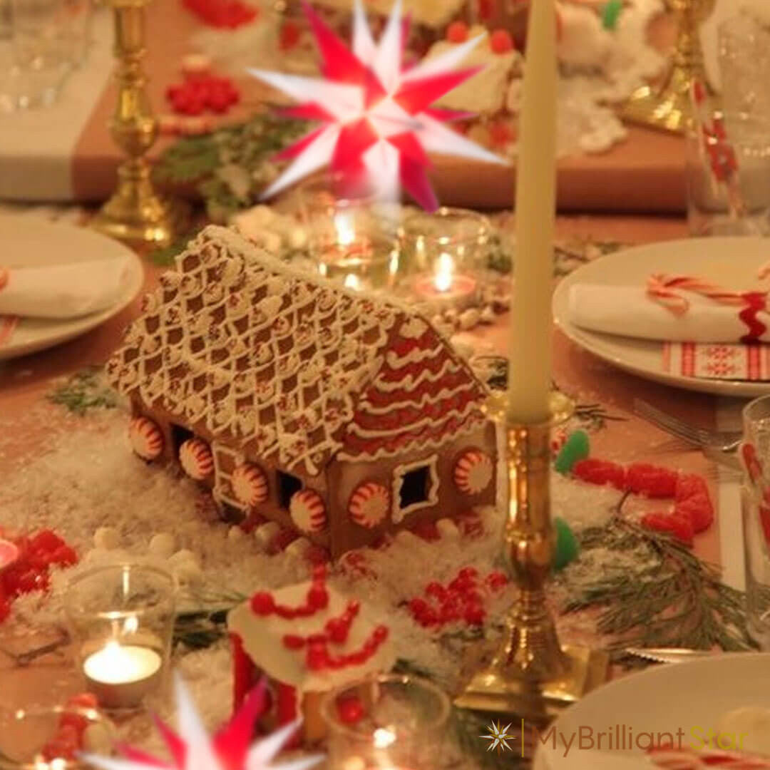 gingerbread house and candles displayed with Original Herrnhut plastic star, white / red, ~ 13 cm / 5 inch ø