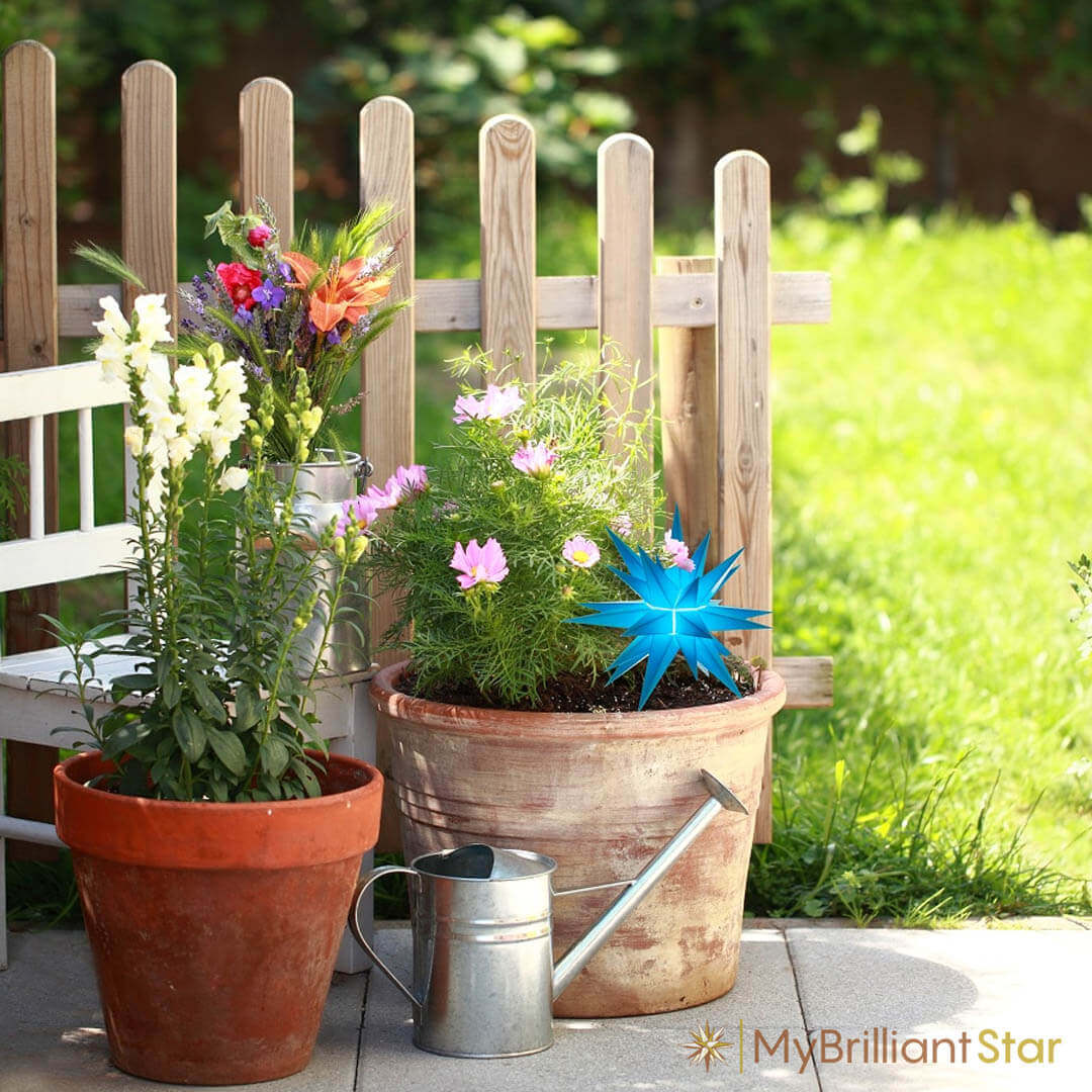 Outdoor flowerpots with spring flowers decorated with the Original Herrnhut plastic star, z-blue, ~ 13 cm / 5 inch ø - LED