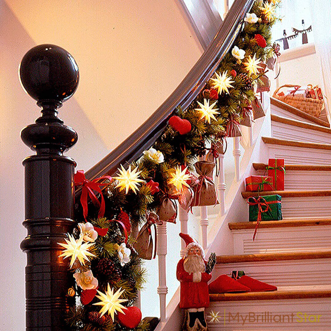 Original Herrnhut plastic star chain, white, decorating a stair case