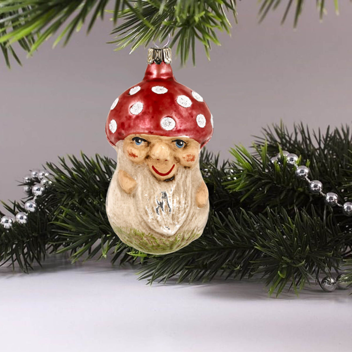 MAROLIN® - Glass ornament &quot;Mushroom with face&quot; hanging on a decorated Christmas tree