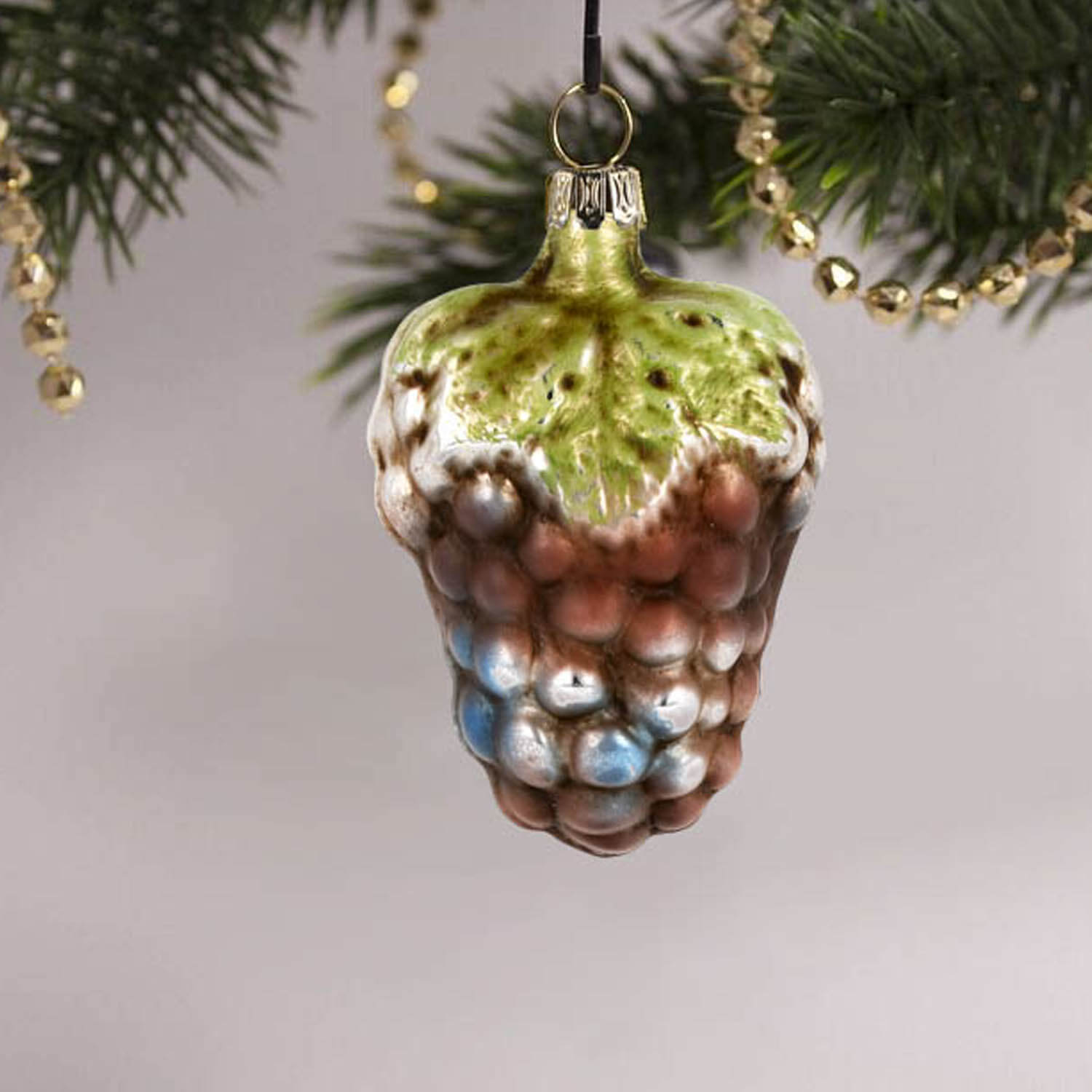 MAROLIN® - Glass ornament "Small grape with leaf" hanging on decorated Christmas tree