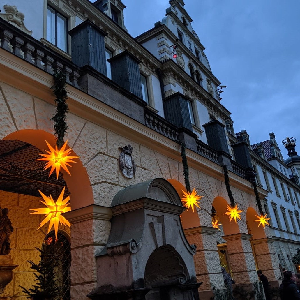 House wall decorated with Original Herrnhut plastic star, yellow, ~ 70 cm / 27 inch ø