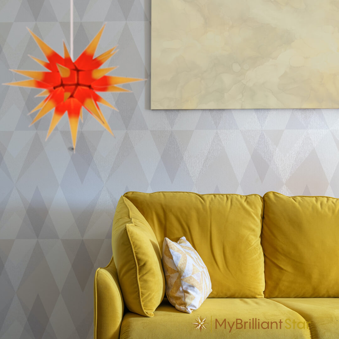 Original Herrnhut paper star, yellow / red center, ~ 60 cm / 24 inch ø hanging in a living room