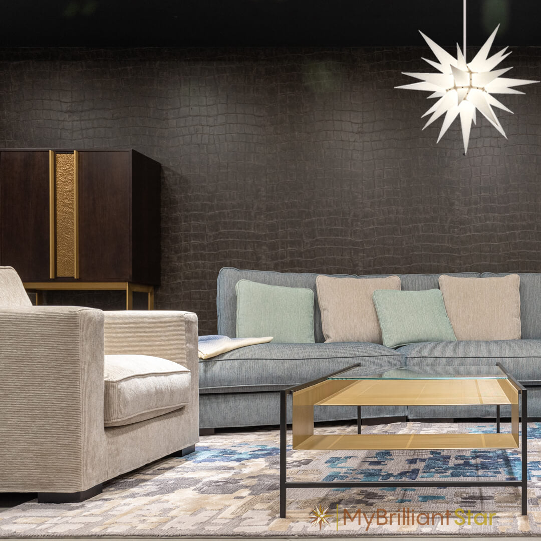 White Herrnhuter star hanging in a living above a table