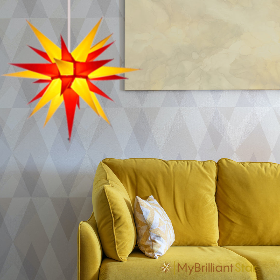 Yello/red Herrnhut paper star hanging in a living room